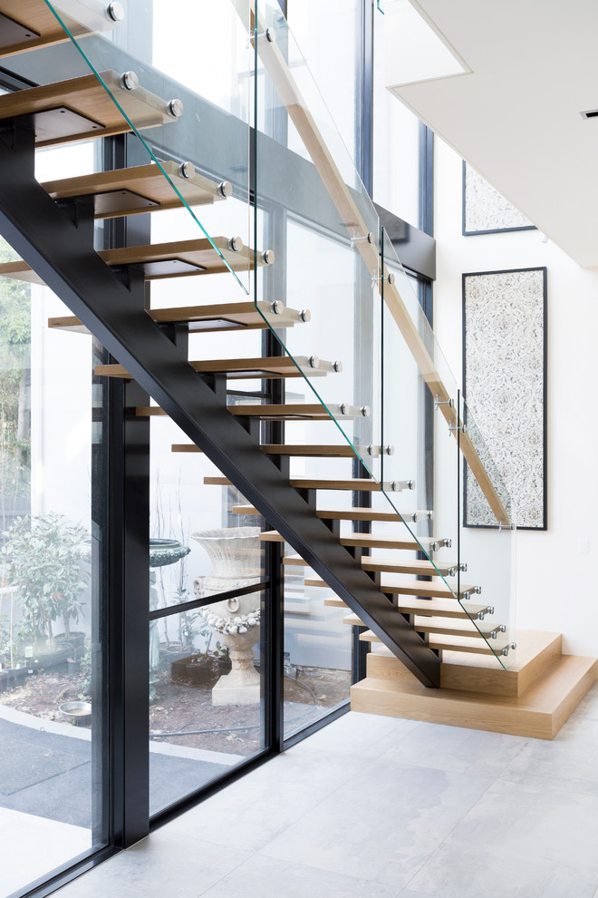 This is an example of a large contemporary wood l-shaped staircase in Melbourne with open risers.