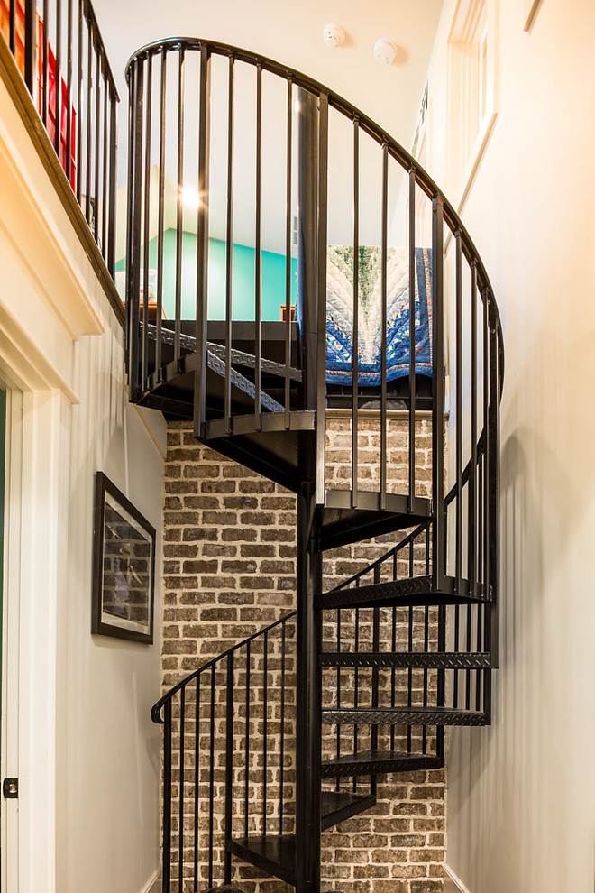 Example of a mountain style spiral staircase design in Atlanta