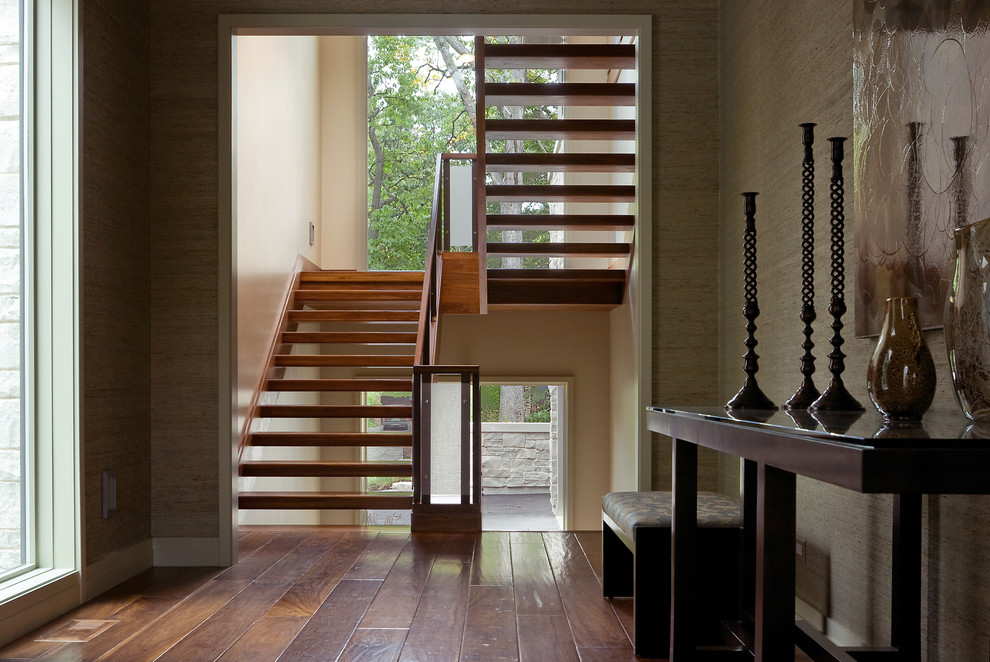 Photo of a contemporary wood u-shaped staircase in Chicago with open risers.