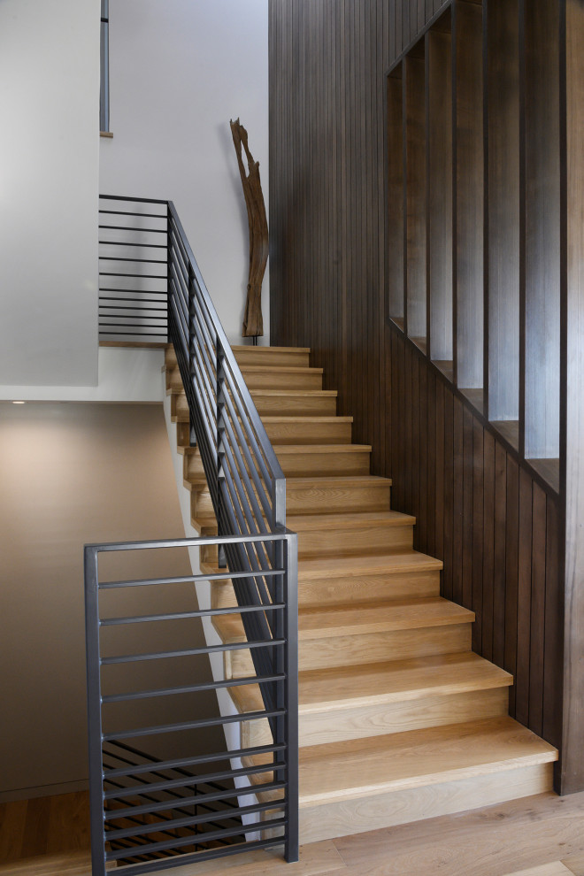 Design ideas for a modern wood l-shaped metal railing staircase in Los Angeles with wood risers.