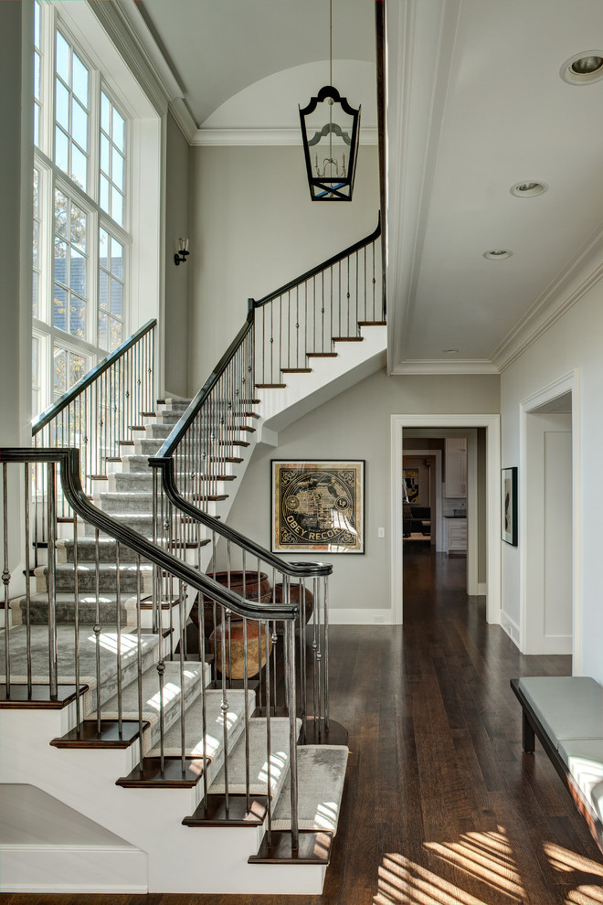 Стильный дизайн: большая угловая лестница в классическом стиле с деревянными ступенями, крашенными деревянными подступенками и деревянными перилами - последний тренд
