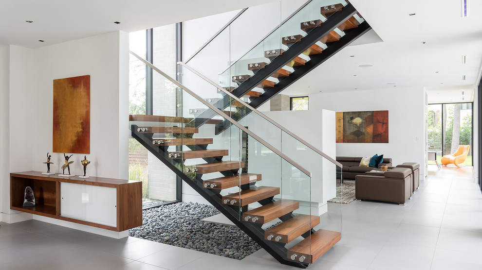 Inspiration for a contemporary wood u-shaped staircase in Houston with open risers.