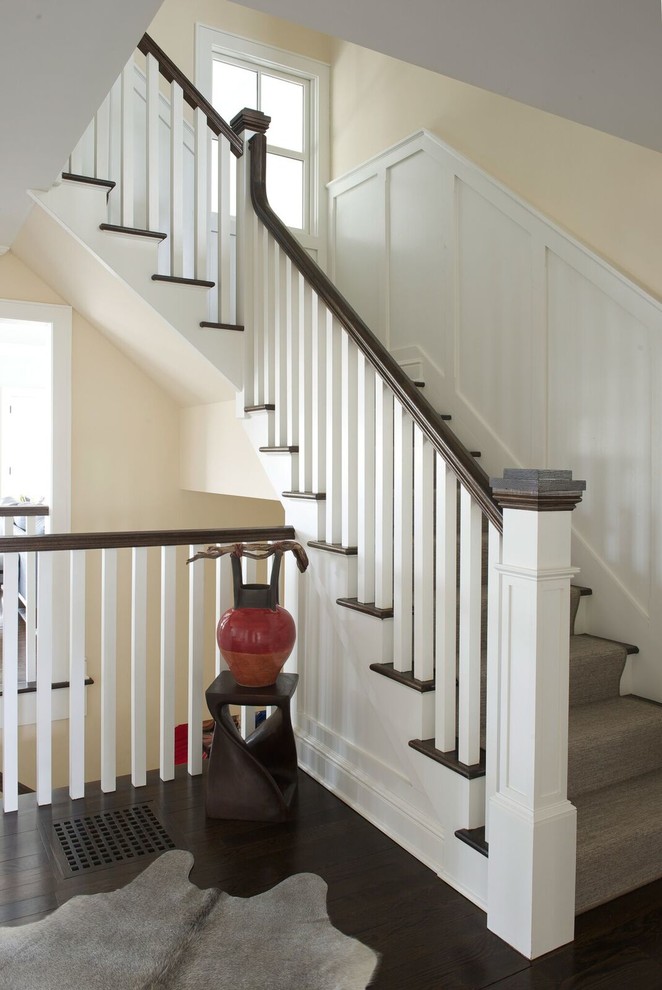 Inspiration for a mid-sized transitional carpeted l-shaped wood railing staircase remodel in DC Metro with carpeted risers