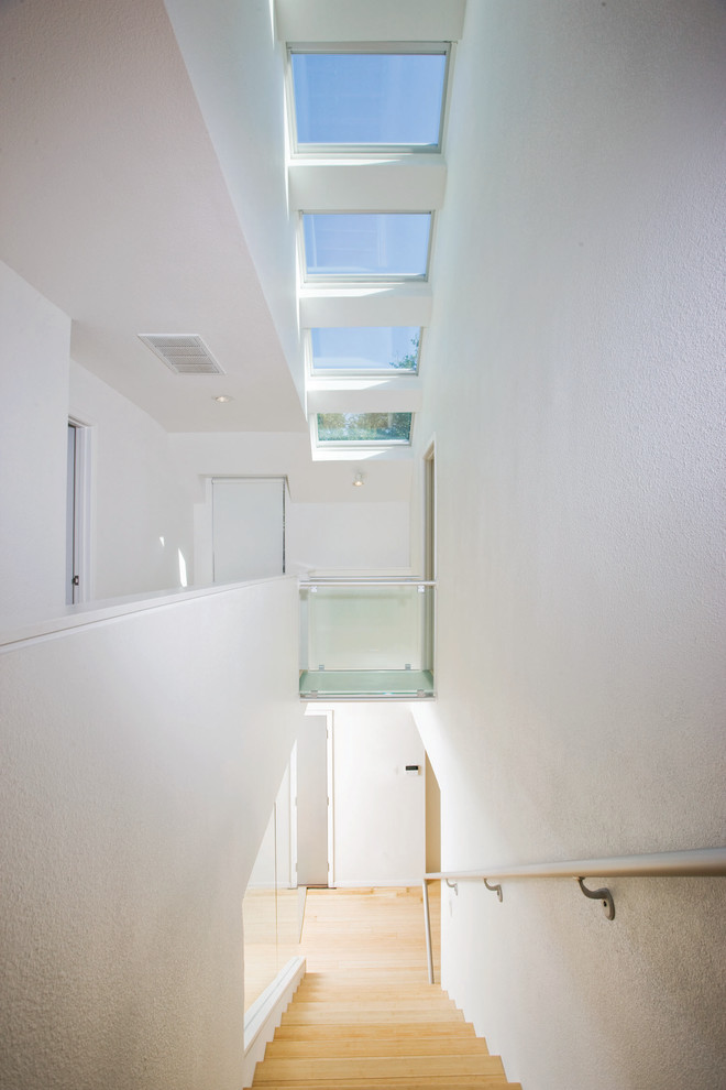 Example of a minimalist wooden straight staircase design in Dallas