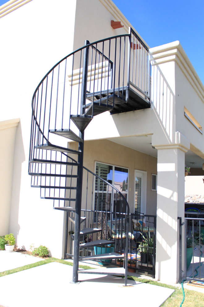 Medium sized classic metal spiral metal railing staircase in Austin with metal risers.