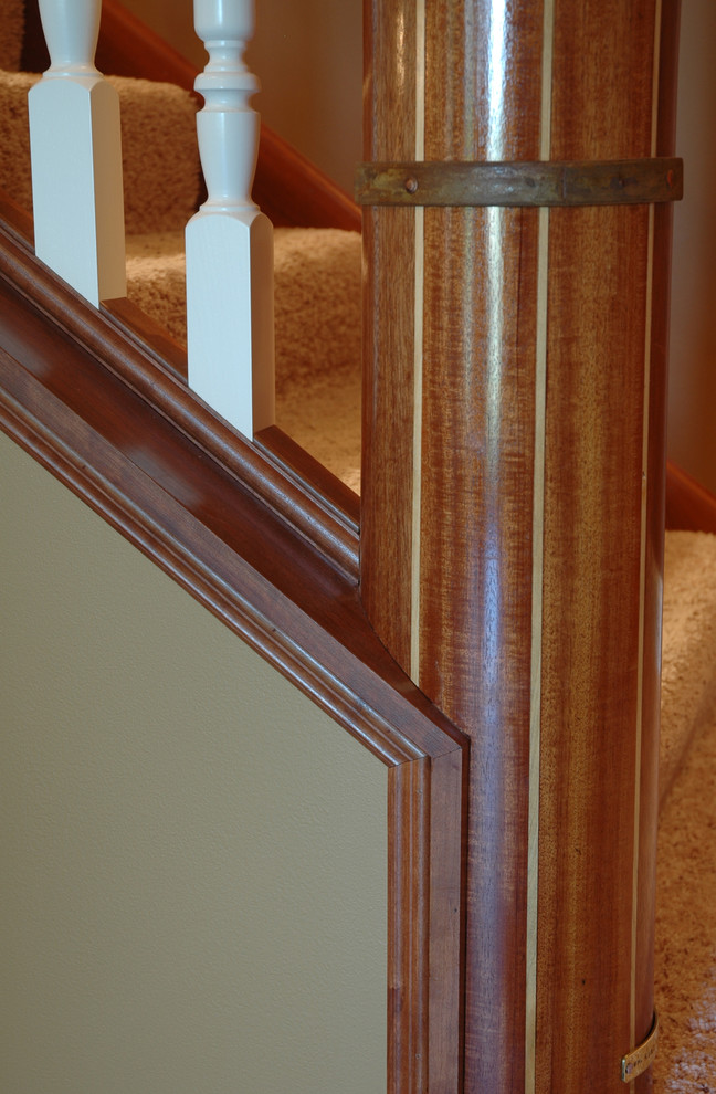 Photo of a contemporary carpeted l-shaped staircase in Minneapolis with wood risers.