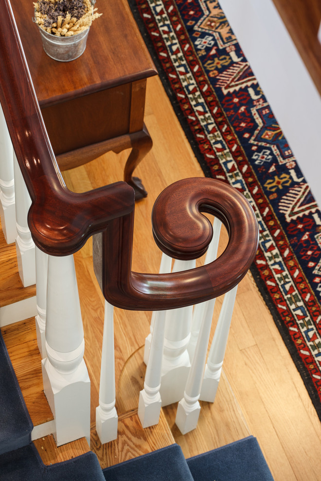 Example of a large classic wooden l-shaped staircase design in Boston with wooden risers