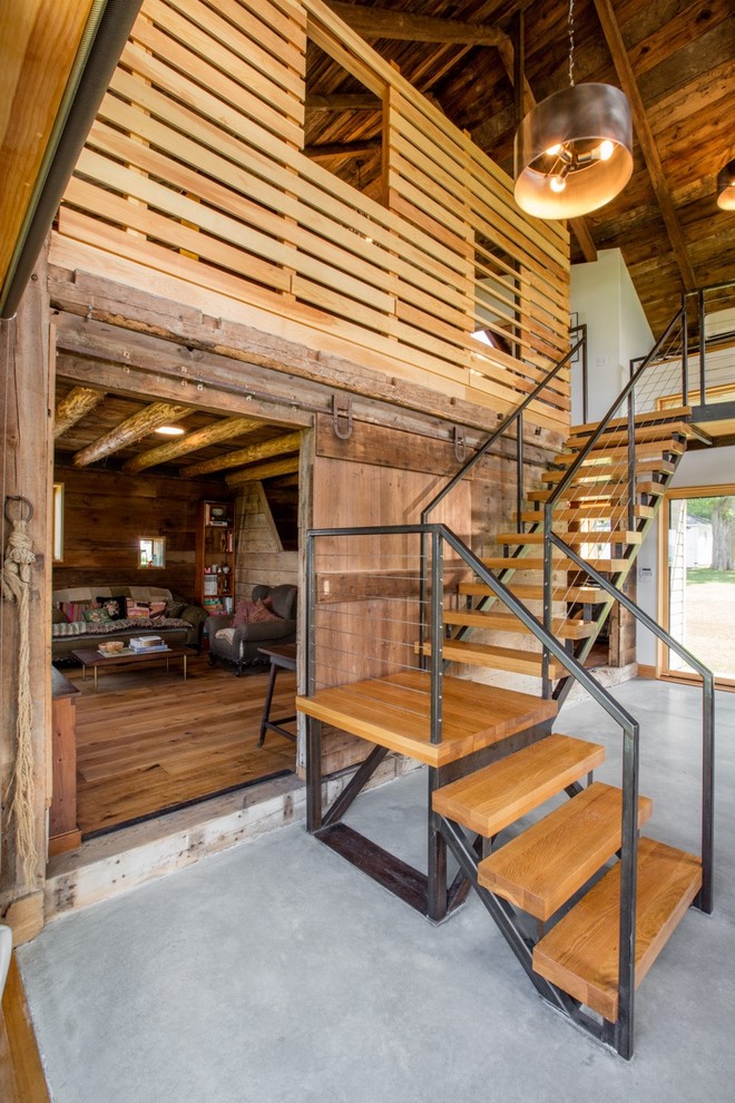 This is an example of a rustic wood l-shaped staircase in Burlington with open risers.