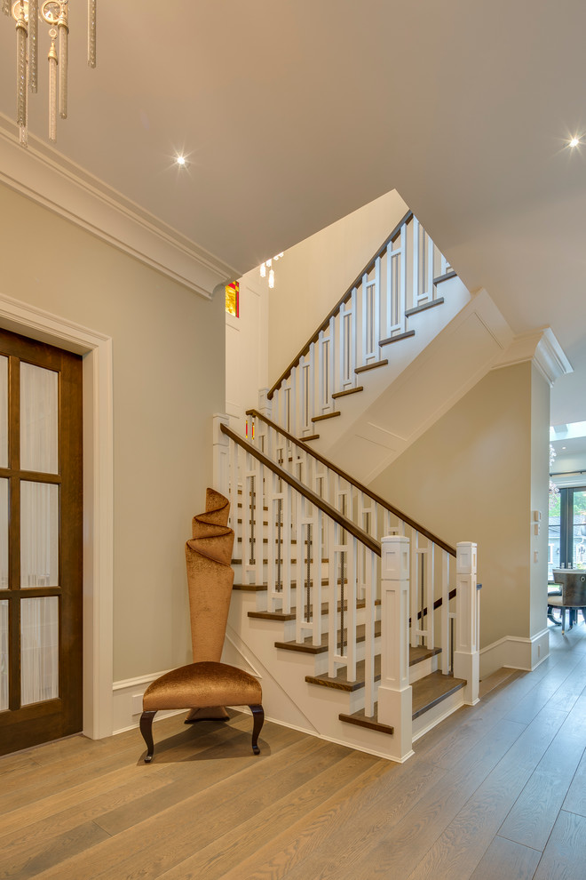Staircase - huge craftsman wooden l-shaped staircase idea in Vancouver with wooden risers
