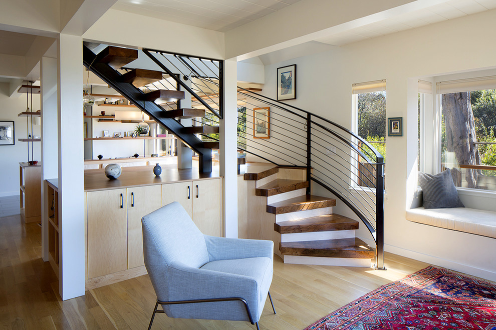 На фото: маленькая изогнутая лестница в морском стиле с деревянными ступенями без подступенок для на участке и в саду