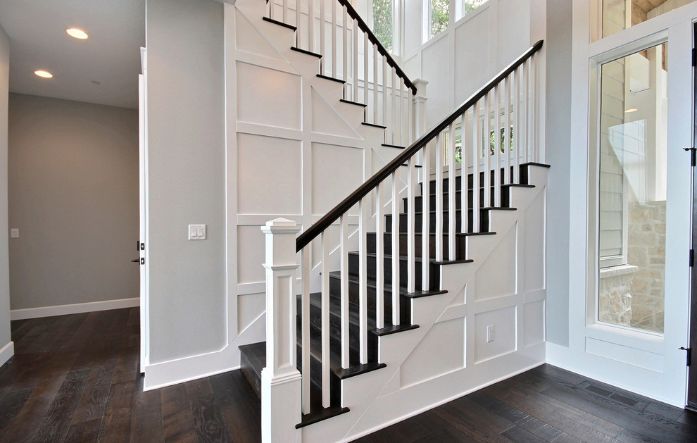 Large classic wood u-shaped wood railing staircase in Portland with wood risers.