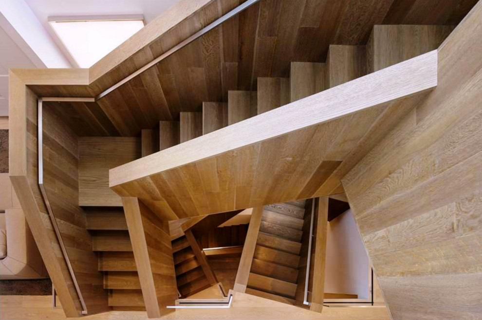 Imagen de escalera en L moderna extra grande con escalones de madera y contrahuellas de madera