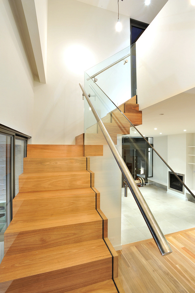 Mid-sized trendy wooden floating staircase photo in Melbourne with wooden risers