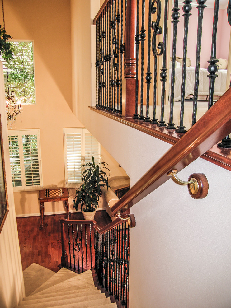 Inspiration for a mid-sized timeless carpeted l-shaped staircase remodel in Orange County with carpeted risers