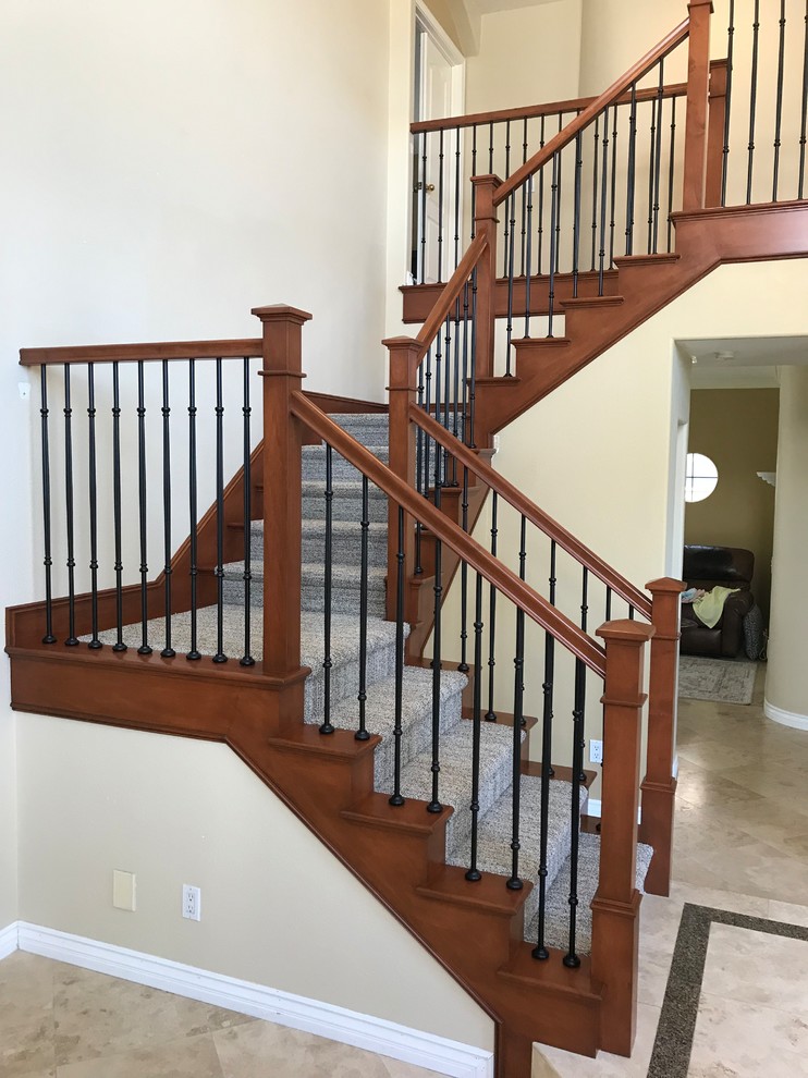 Large transitional carpeted u-shaped mixed material railing staircase photo in Orange County with carpeted risers