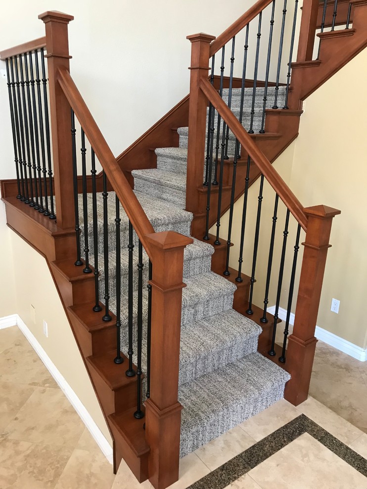 Design ideas for a large classic carpeted u-shaped mixed railing staircase in Orange County with carpeted risers.