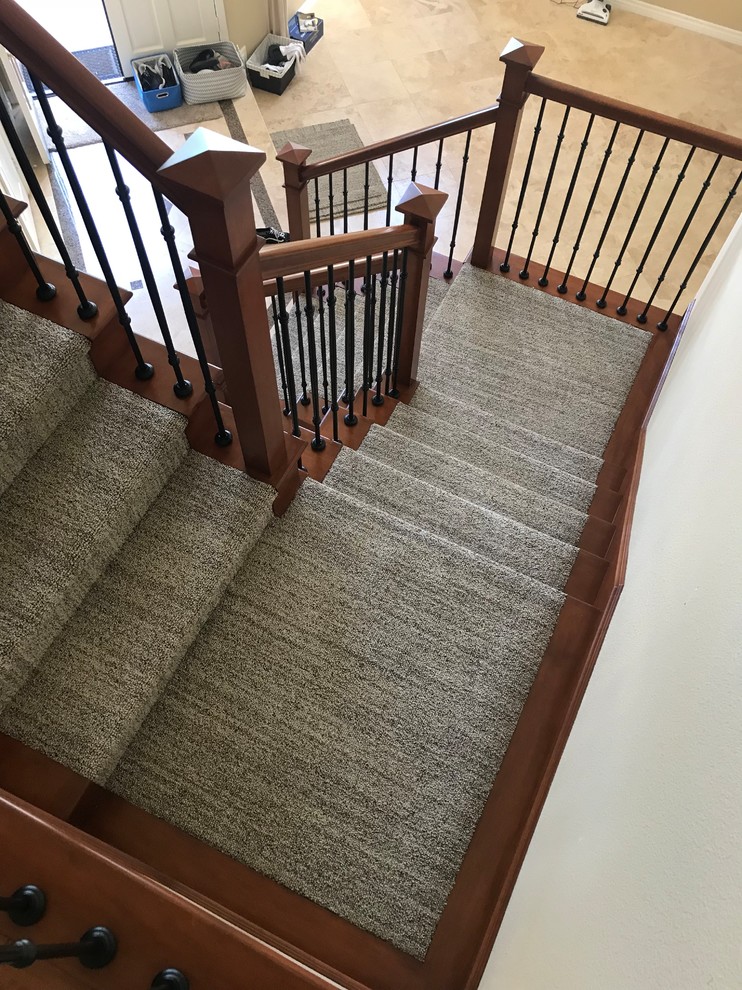 Example of a large transitional carpeted u-shaped mixed material railing staircase design in Orange County with carpeted risers