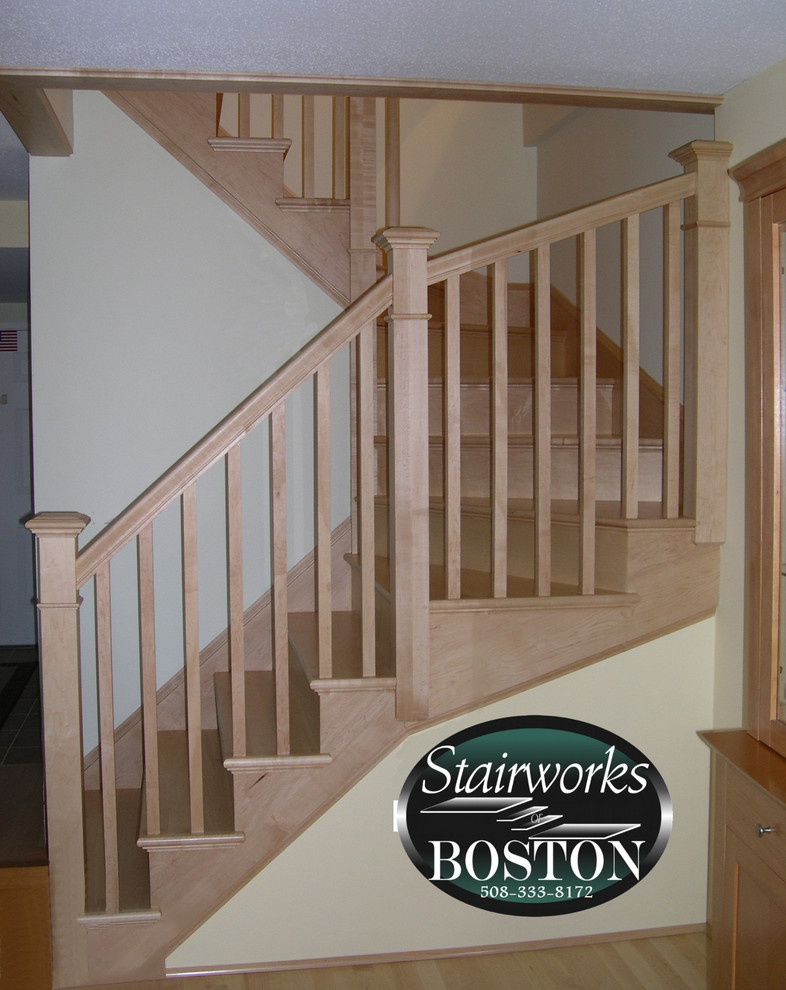 Small contemporary wood u-shaped staircase in Boston with wood risers.