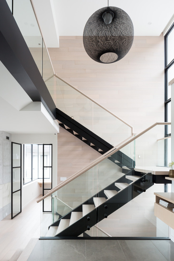 Ejemplo de escalera suspendida actual de tamaño medio sin contrahuella con escalones de madera y barandilla de vidrio