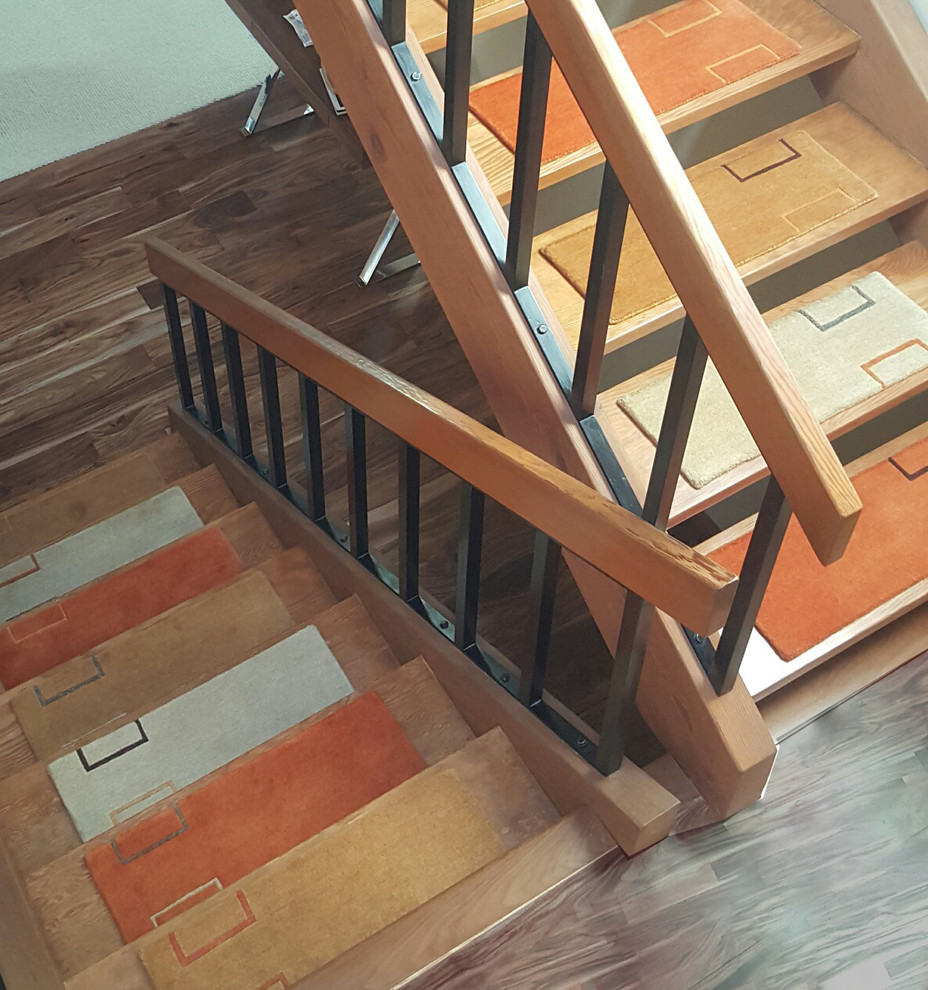 Inspiration for a medium sized modern carpeted straight staircase in New York with open risers.