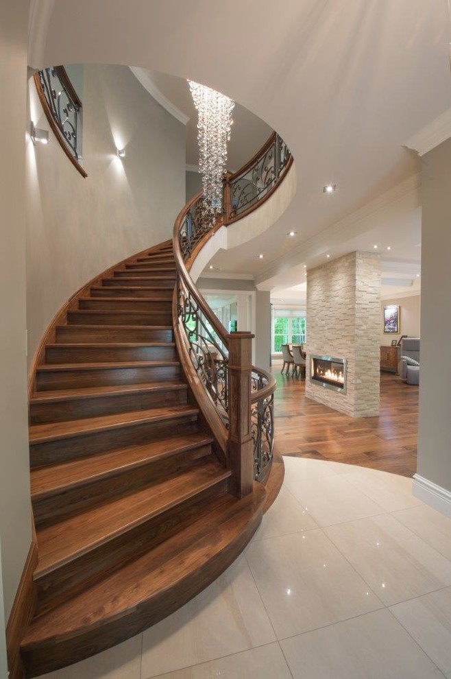 Design ideas for a large traditional wood spiral staircase in Toronto with wood risers.