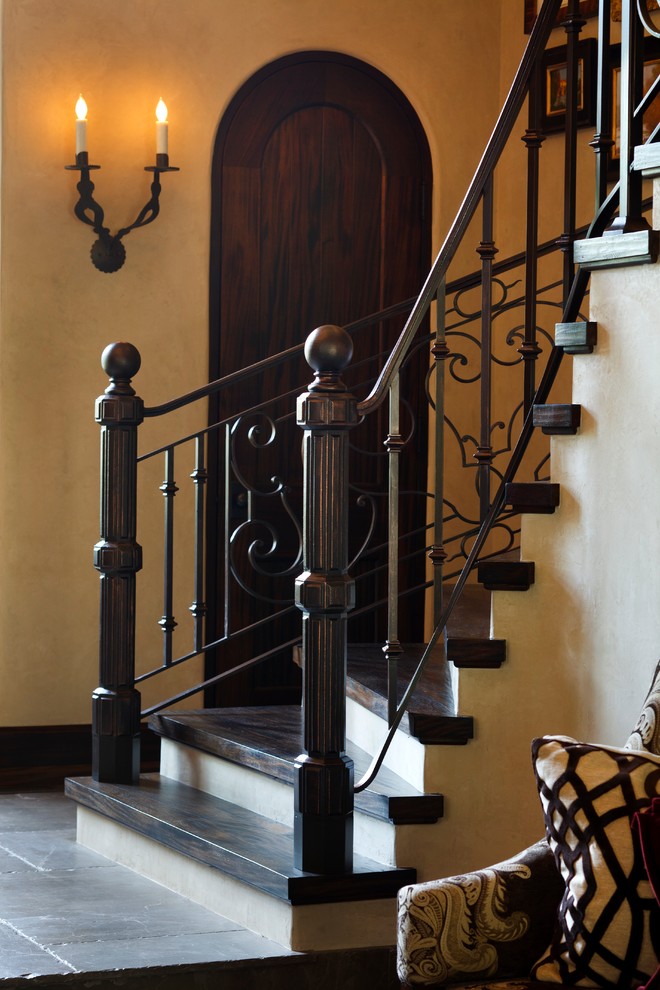 Staircase - mediterranean wooden metal railing staircase idea in Wichita