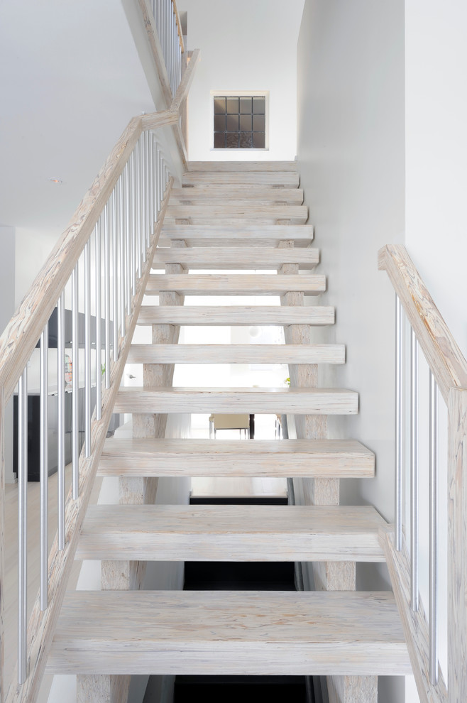 Medium sized scandinavian wood straight staircase in Ottawa with open risers.