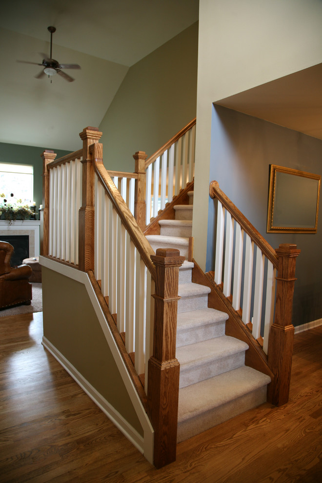 Staircase - small traditional carpeted l-shaped wood railing staircase idea in Milwaukee with carpeted risers