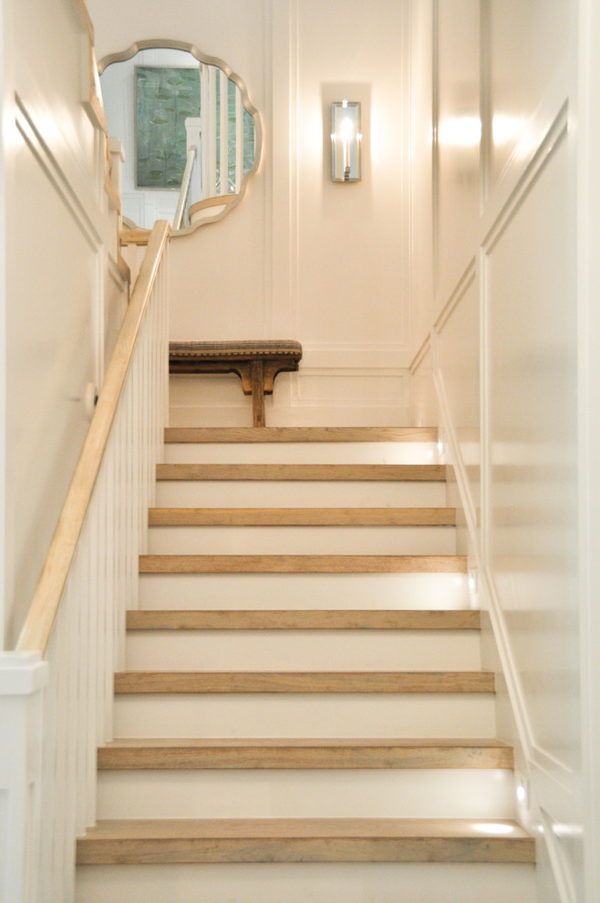Example of a mid-sized beach style wooden u-shaped wood railing staircase design in Miami with painted risers