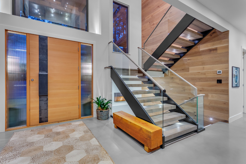 На фото: п-образная лестница в современном стиле с бетонными ступенями без подступенок с
