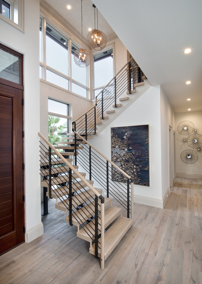 This is an example of an expansive contemporary wood u-shaped staircase in Tampa with open risers.