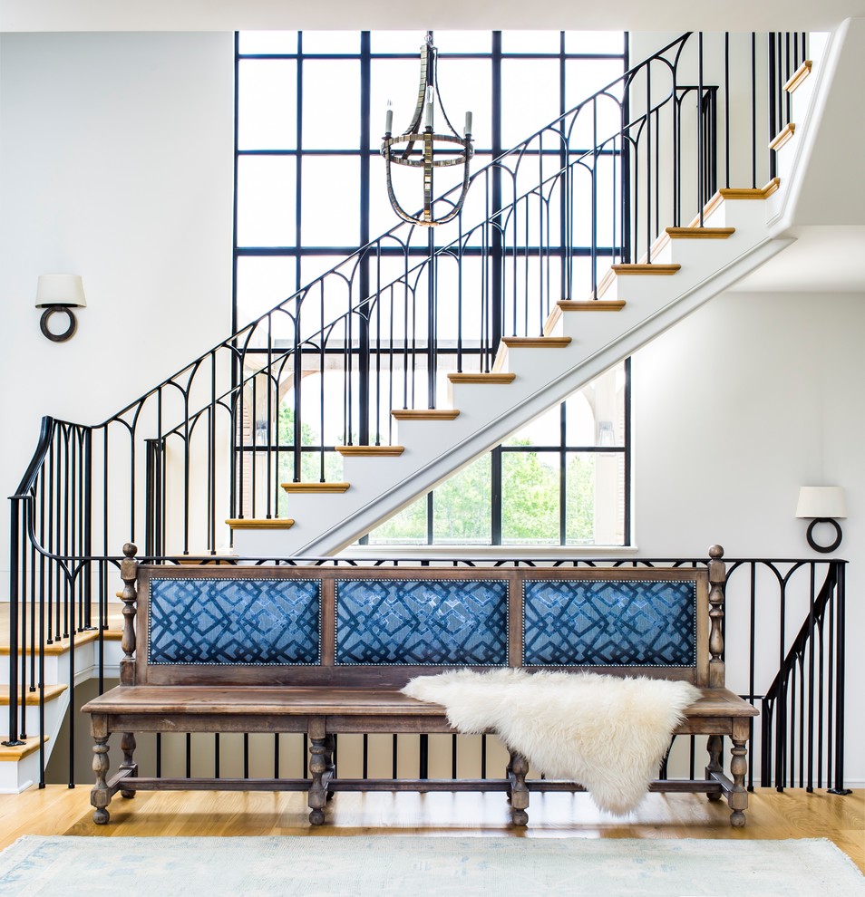 Transitional wooden u-shaped metal railing staircase photo in Atlanta with painted risers