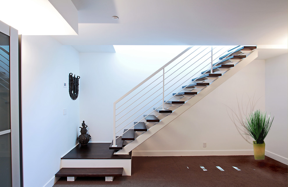 Exemple d'un grand escalier sans contremarche flottant chic avec des marches en bois.