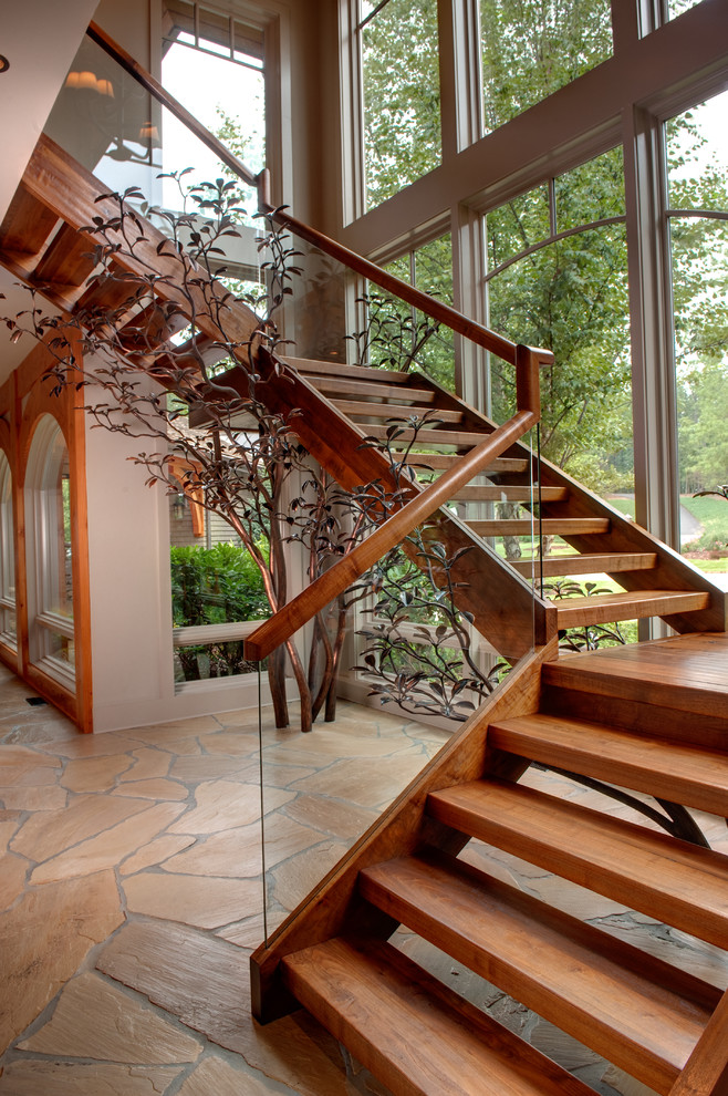 Example of a mountain style floating open and glass railing staircase design in Atlanta