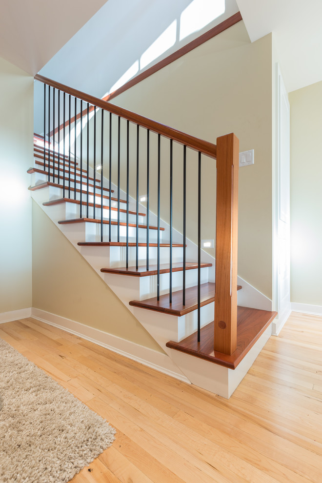 Foto de escalera recta actual de tamaño medio con escalones de madera y contrahuellas de madera pintada