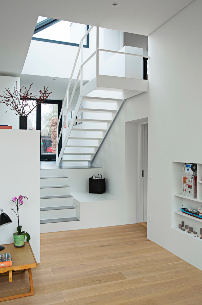 Diseño de escalera actual de tamaño medio con escalones de madera pintada