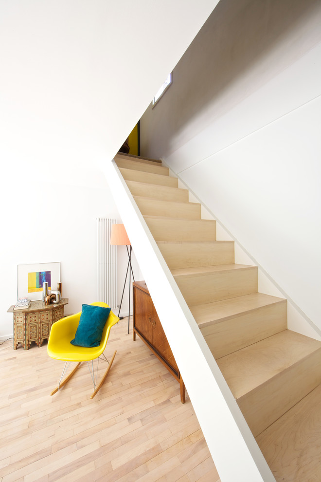 Wood straight staircase in London with wood risers.