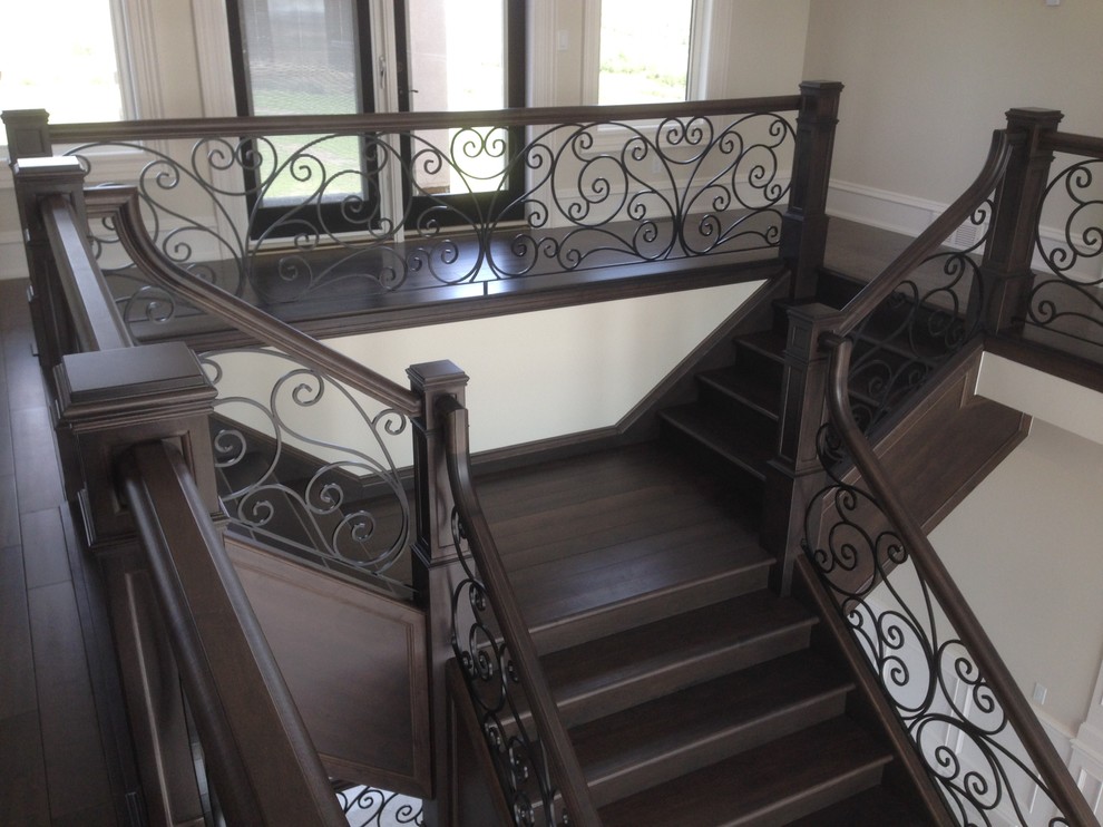 Example of a large classic wooden curved wood railing staircase design in Other with wooden risers