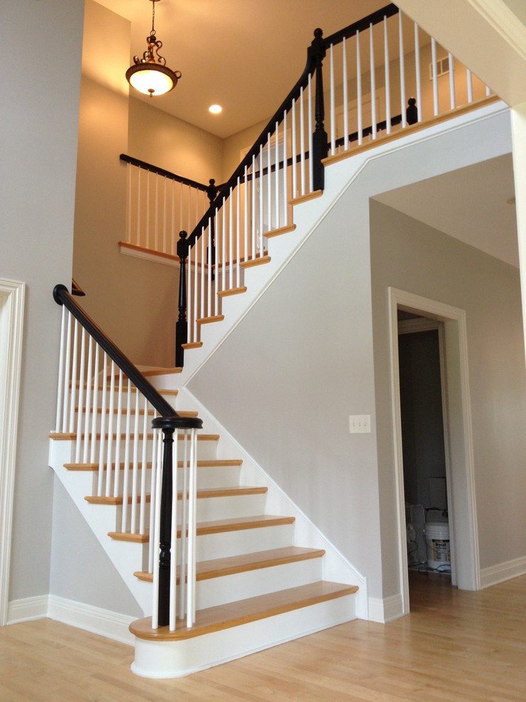 Inspiration for a modern wooden u-shaped staircase remodel in Chicago with wooden risers