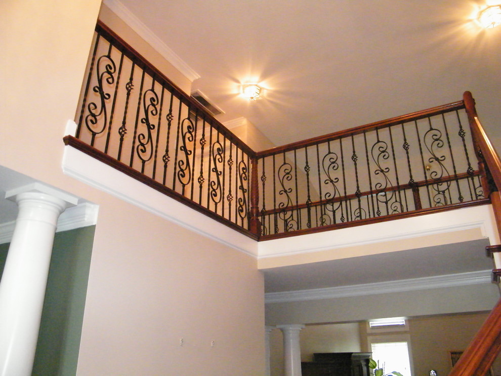 Large classic wood straight staircase in Raleigh with open risers.