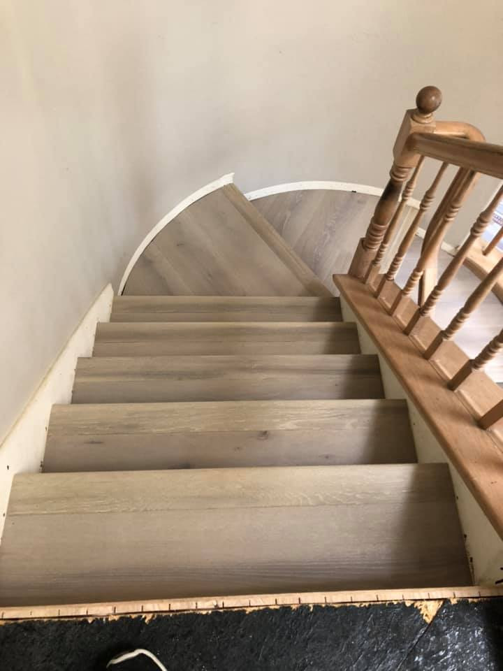 Example of a large classic wooden curved wood railing staircase design in San Diego with wooden risers