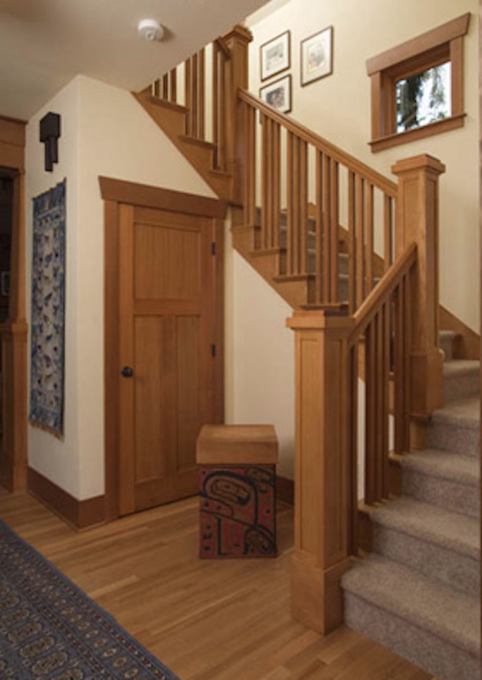 This is an example of a rustic carpeted l-shaped staircase in Seattle with carpeted risers.