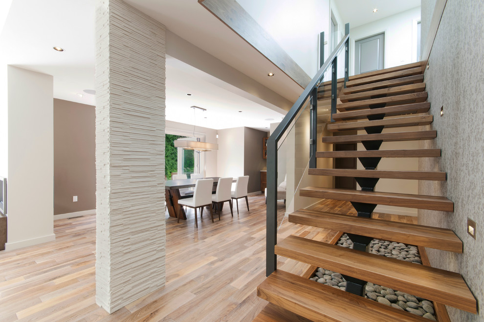 Example of a mid-sized transitional wooden floating open and glass railing staircase design in Vancouver