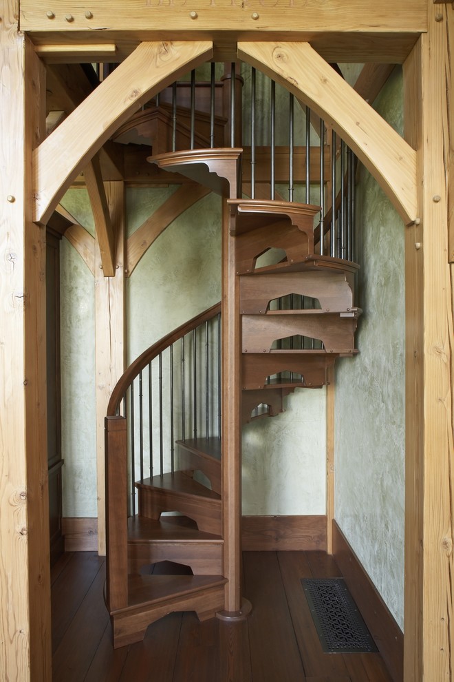 Example of a mountain style wooden spiral staircase design in Jackson with wooden risers