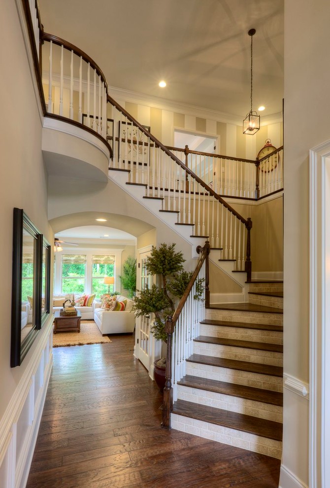 Classic wood l-shaped wood railing staircase in Atlanta with tiled risers.
