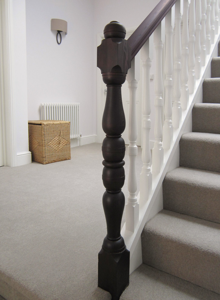 Inspiration for a medium sized traditional carpeted l-shaped wood railing staircase in London with carpeted risers.