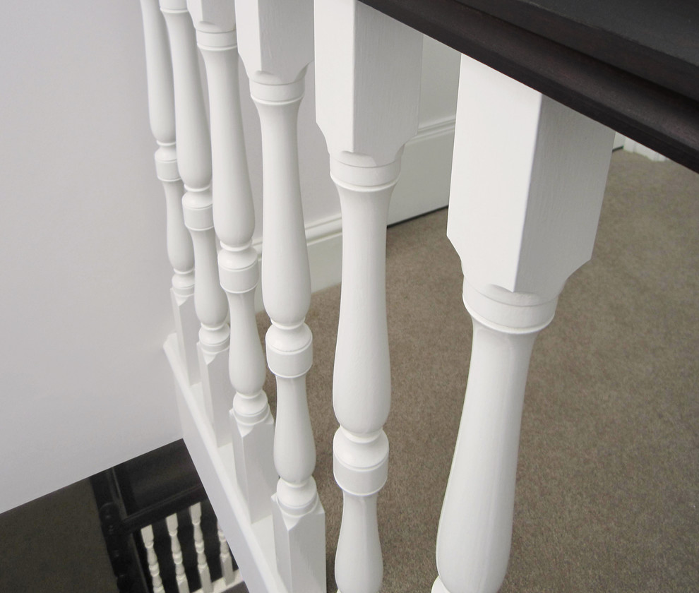 Design ideas for a medium sized classic carpeted l-shaped wood railing staircase in London with carpeted risers.