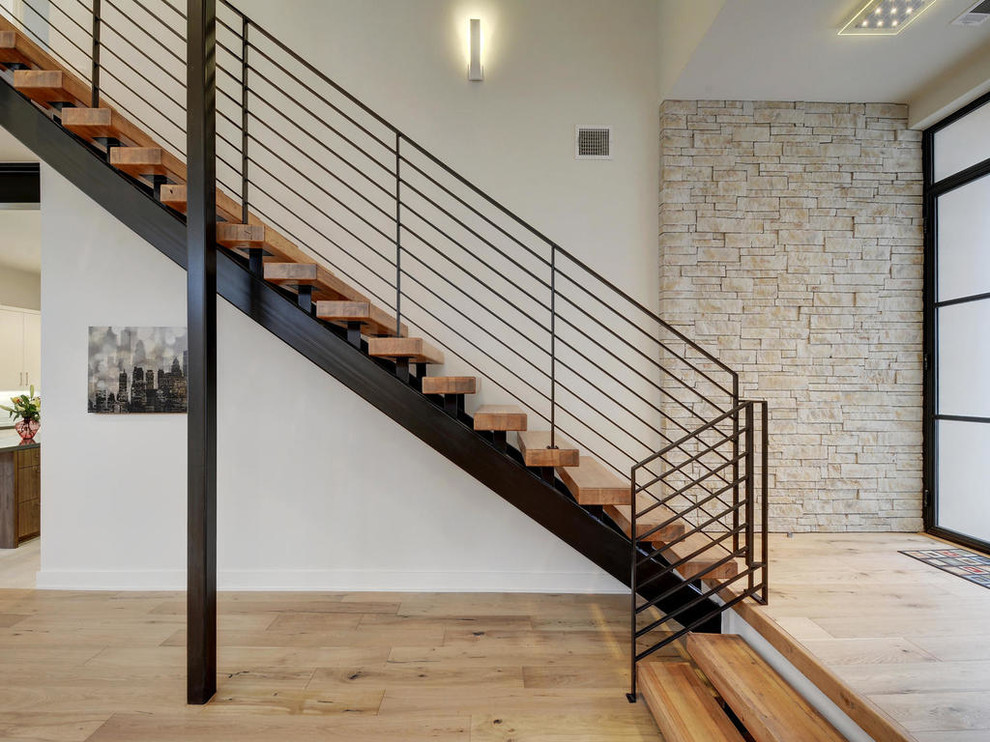 Large trendy wooden straight open staircase photo in Austin