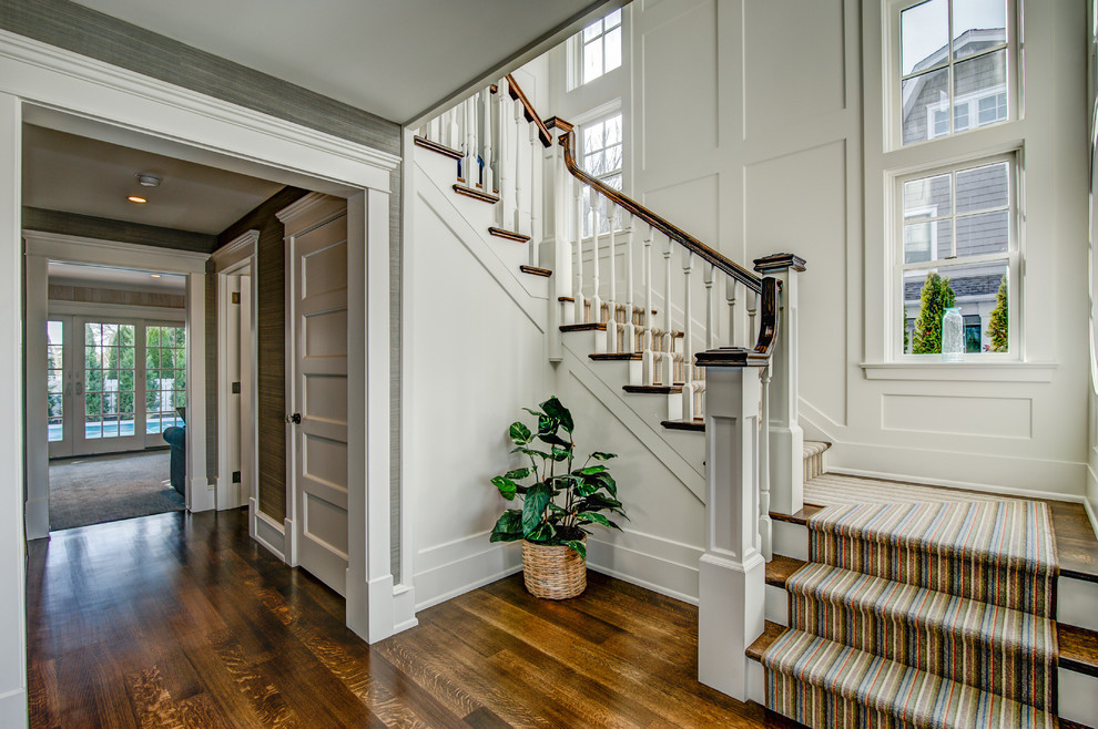 Example of a large classic wooden u-shaped wood railing staircase design in Philadelphia with painted risers