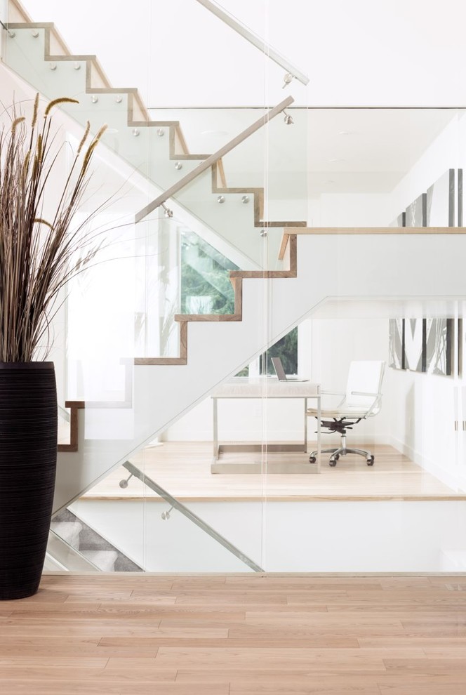 Inspiration for a contemporary wood u-shaped staircase in Calgary with wood risers.